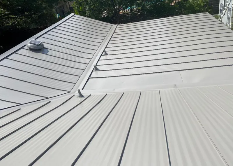 Solar attic fan installed on a metal roof for Roof Ventilation in Forks